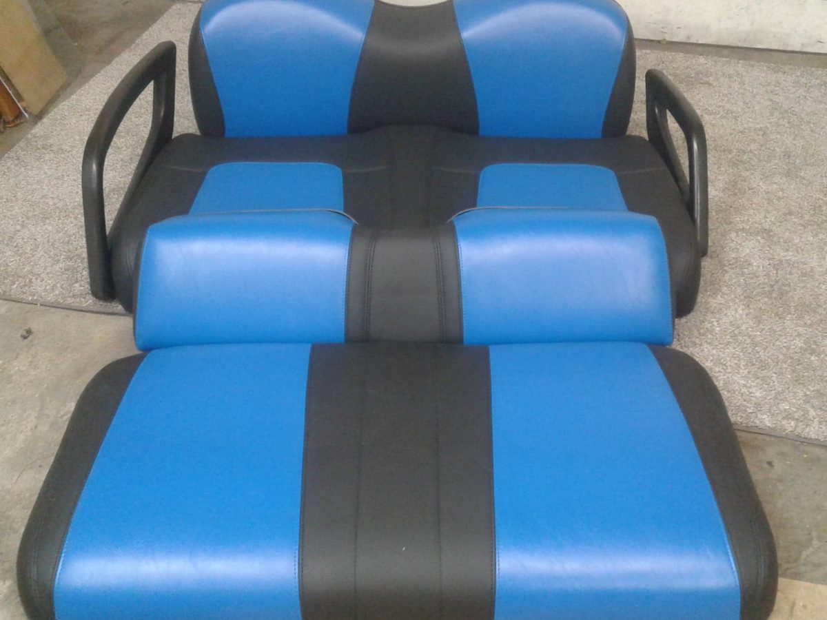 A cart bench seat and backrest recovered in blue vinyl with black centre stripes.