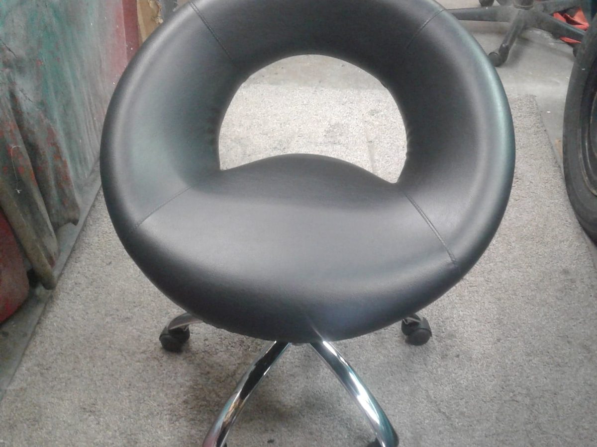 A round-backed swivel chair on a chrome base, recovered in black.